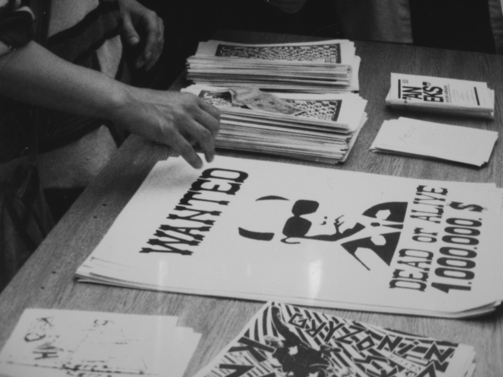 A scene from the happening 'The Day After' carried on Piotrkowska street in Łódź, June 06, 1989. Posters 'Wanted' by Krzysztof Raczyński are placed on the table for sale during the event.