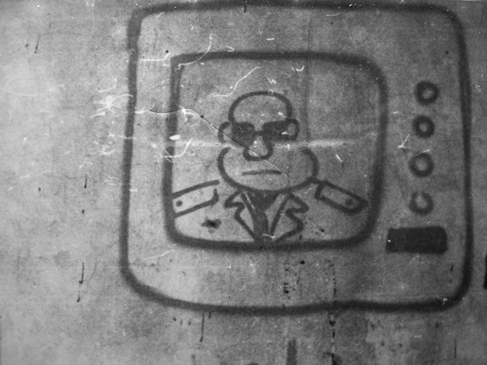 Photo of graffiti painted by Krzysztof Skiba on the wall in Łódź in 1989. The picture of a man in black eyeglasses in the TV was an obvious caricature of general Wojciech Jaruzelski.