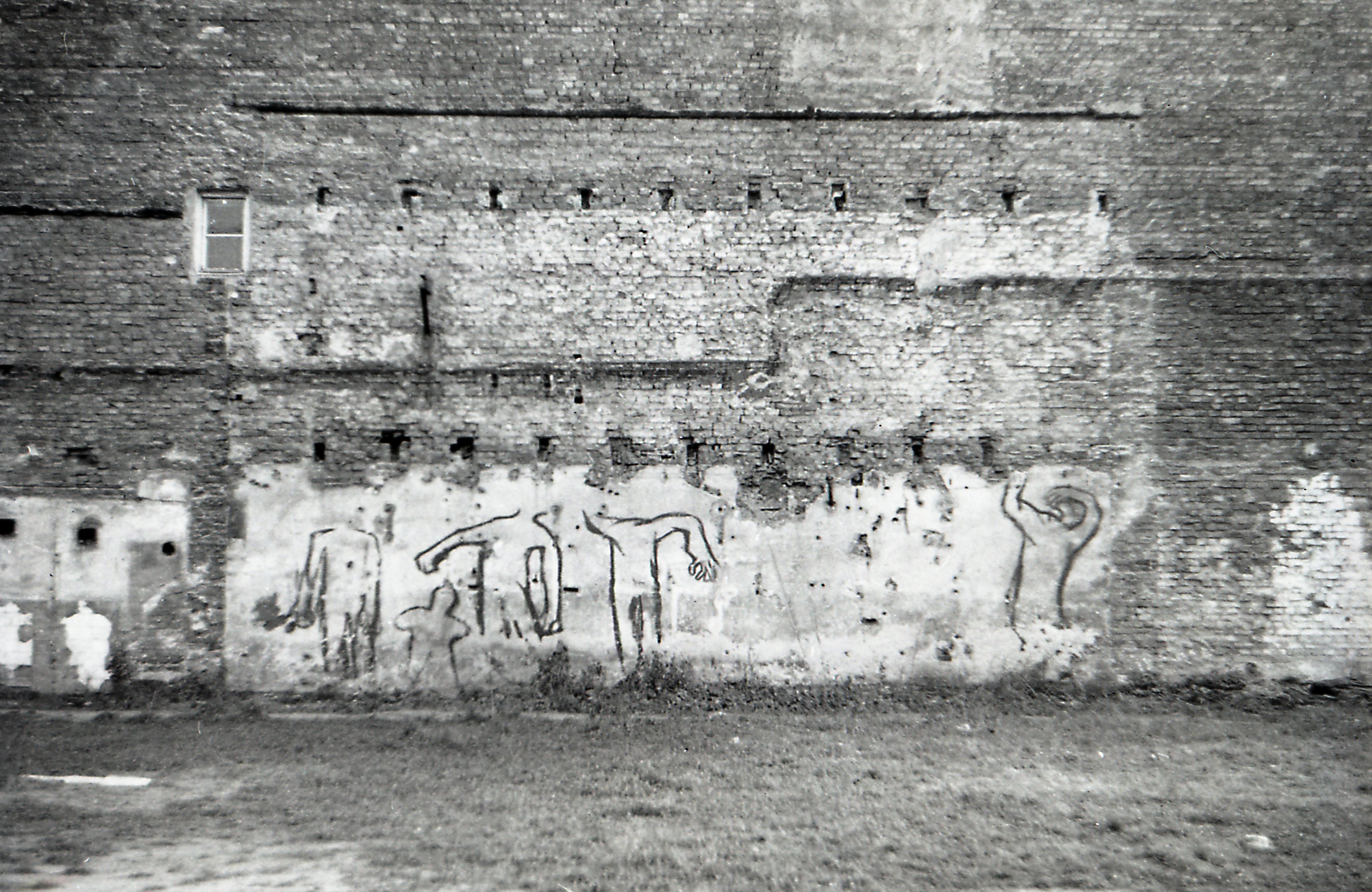 The photo showed the graffiti called 'Taniec śmierci' (Dance of Death) painted by Włodzimierz Fruczek on Waliców street, Warsaw, 1970. Tomasz Sikorski took this photo in 1974.