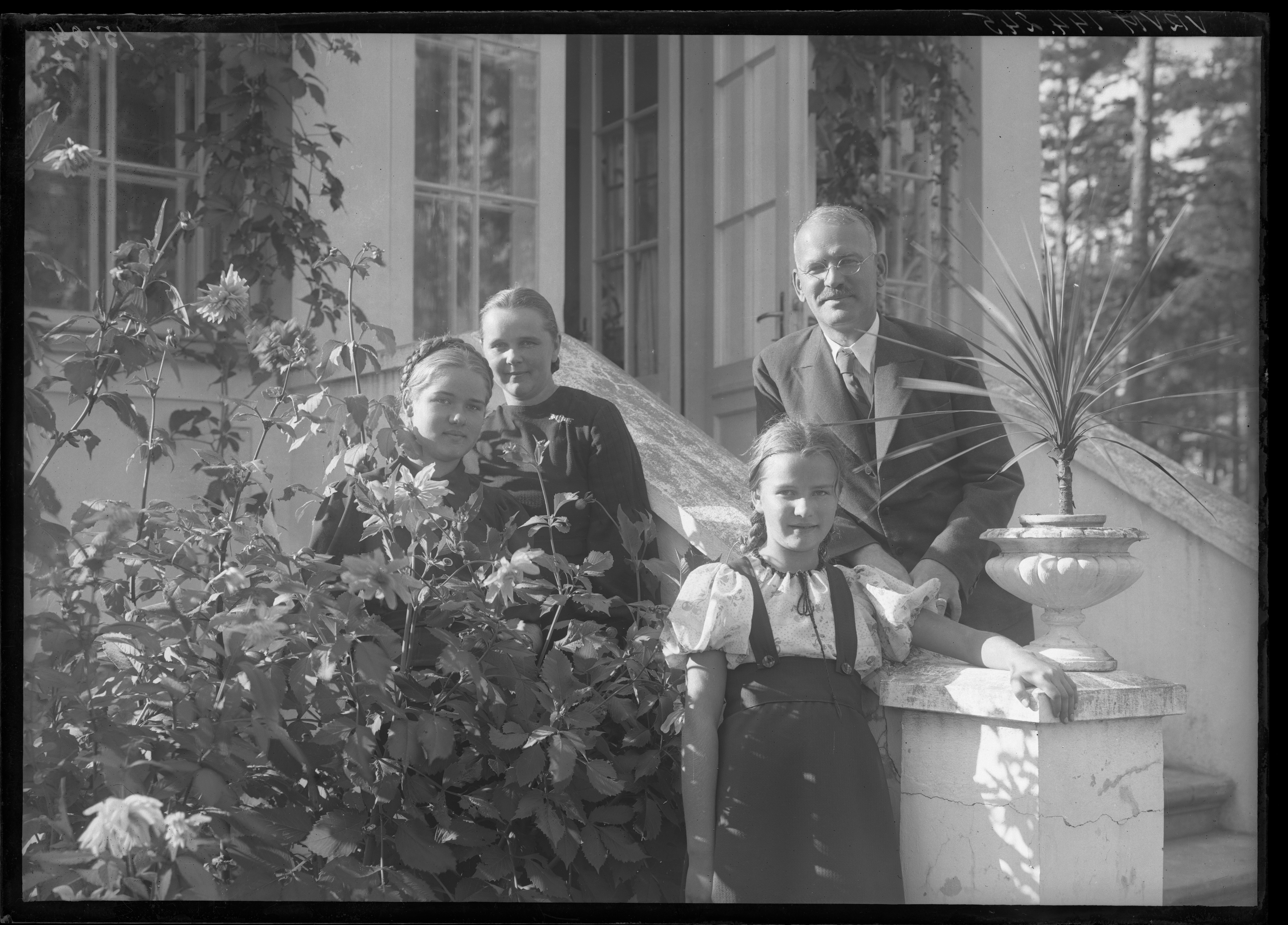 Portrait of philisopher, professor of Latvian University Pauls Dāle (1889-1968) with his family in front of their house in Mežaparks, Riga, taken by Krišs Rake in 1936. P. Dāle was a disciple of E. Husserl, the most prominent philosopher in the interwar Latvia, founder of the Institute of Psychology of the Latvian University in 1938. Due to his philosophic and religious thoughts P. Dāle was fired from the Latvian State University in 1948 and deprived from possibility to do academic research. Although 5 years later he was allowed to work at the Institute of Language and Literature of the Latvian SSR Academy of Sciences and later also earned living by translations from Russian. The last years of his life were spent in poverty and isolation. VRVM 144.245